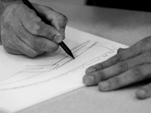 Black and white picture of somone sketching a shoe
